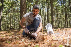 Kaizad - who received his undergraduate degree in India - is sampling forest soils for study of their role in carbon storage. (University of Maine)